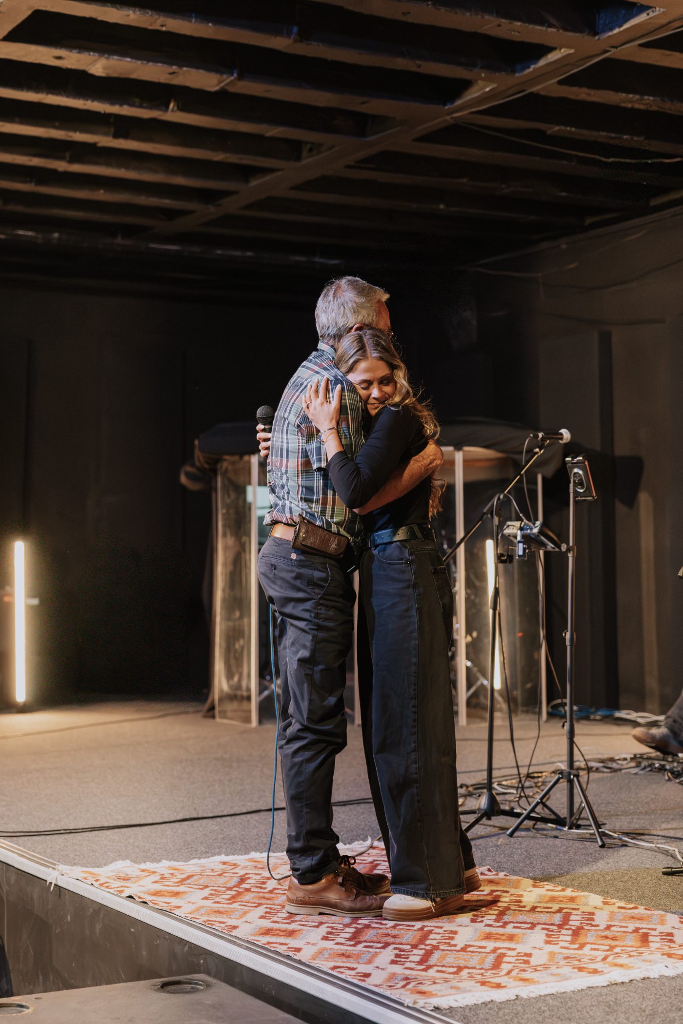 Two MissioSA leaders embracing on stage